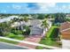 Beautiful single-Gathering home featuring a brick driveway, attached two-car garage, palm trees, and a well-manicured lawn at 5320 Layton Dr, Venice, FL 34293