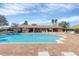 Community pool with lounge chairs and covered seating area in a brick-paved area at 5320 Layton Dr, Venice, FL 34293
