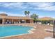 Community pool with lounge chairs and covered seating area with palm trees at 5320 Layton Dr, Venice, FL 34293