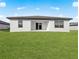 Spacious backyard with lush green grass and a covered patio at 5521 Colfax Ter, Port Charlotte, FL 33981