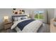 Cozy bedroom featuring a comfortable bed, natural light, and stylish decor at 5521 Colfax Ter, Port Charlotte, FL 33981