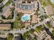 Aerial view of community amenities, including a pool, parking, and nearby lush landscaping at 5531 Cannes Cir # 201, Sarasota, FL 34231