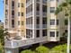 Expansive screened-in balcony with plush outdoor seating, overlooking tropical foliage and scenic surroundings at 5531 Cannes Cir # 201, Sarasota, FL 34231