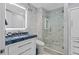 Elegant bathroom featuring glass shower, marble tiling, and blue granite sink top at 5531 Cannes Cir # 201, Sarasota, FL 34231