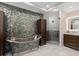Stylish bathroom with elegant standalone tub, unique wall texture and adjacent shower at 5531 Cannes Cir # 201, Sarasota, FL 34231
