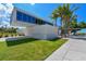 The Siesta Beach sign is nestled amongst palm trees and green grass at 5531 Cannes Cir # 201, Sarasota, FL 34231