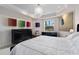Bright bedroom featuring tray ceilings, colorful art and modern black dressers with great natural light at 5531 Cannes Cir # 201, Sarasota, FL 34231