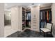 Custom walk-in closet with storage solutions and access to the primary bathroom at 5531 Cannes Cir # 201, Sarasota, FL 34231