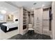 Spacious walk-in closet featuring custom shelving, drawers, and gray marbled tile flooring at 5531 Cannes Cir # 201, Sarasota, FL 34231