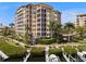 Mediterranean-style building showcases private boat docks, mature landscaping, and tranquil waterfront scenery at 5531 Cannes Cir # 201, Sarasota, FL 34231