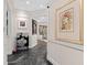Stylish entryway features elegant decor, modern artwork, and sleek black marble flooring at 5531 Cannes Cir # 201, Sarasota, FL 34231