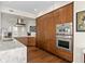 Contemporary kitchen with wood cabinets, marble backsplash, and stainless steel appliances, including double ovens at 5531 Cannes Cir # 201, Sarasota, FL 34231