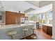 Modern kitchen with stainless steel appliances, marble counters, and large windows with water views at 5531 Cannes Cir # 201, Sarasota, FL 34231
