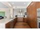 Spacious modern kitchen with stainless appliances, marble counters and backsplash, and wood cabinets at 5531 Cannes Cir # 201, Sarasota, FL 34231