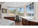 Kitchen nook features a custom desk and drawers, with water views from the three large windows at 5531 Cannes Cir # 201, Sarasota, FL 34231