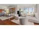 Bright living area with hardwood floors, chic furnishings, and expansive windows offering stunning waterfront views at 5531 Cannes Cir # 201, Sarasota, FL 34231