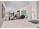Bright open-concept living space and kitchen with sleek marble countertops and stainless steel sink at 5531 Cannes Cir # 201, Sarasota, FL 34231