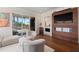 Inviting living room with a large TV, fireplace, plush seating, and a seamless transition to an outdoor patio at 5531 Cannes Cir # 201, Sarasota, FL 34231