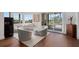 Elegant living room boasts contemporary furnishings, smooth hardwood floors, and sliding doors to outdoor views at 5531 Cannes Cir # 201, Sarasota, FL 34231