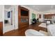 Open-concept design with TV over a fireplace, adjacent to an open doorway leading to a chef's kitchen at 5531 Cannes Cir # 201, Sarasota, FL 34231