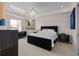 Stylish main bedroom with a black upholstered bed frame, side tables, and serene decor at 5531 Cannes Cir # 201, Sarasota, FL 34231