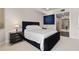 Serene main bedroom with a plush black bed frame, contemporary decor, and plush carpeting at 5531 Cannes Cir # 201, Sarasota, FL 34231