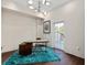 Bright home office featuring a modern desk, stylish lighting, and a door to the outside at 5531 Cannes Cir # 201, Sarasota, FL 34231