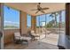 Enclosed patio with outdoor seating, ceiling fan, and view of the water at 5531 Cannes Cir # 201, Sarasota, FL 34231