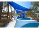 Fun playground with blue shade canopy, slides, and play equipment in a well-maintained area at 5531 Cannes Cir # 201, Sarasota, FL 34231
