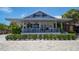 Modern restaurant with a sleek facade, outdoor seating, manicured hedges, and ample parking at 5531 Cannes Cir # 201, Sarasota, FL 34231
