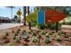 Charming Siesta Key Village welcome sign surrounded by colorful flowers and tropical landscaping at 5531 Cannes Cir # 201, Sarasota, FL 34231
