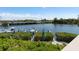 Scenic water view featuring boat docks, lush greenery, and a bridge in the background at 5531 Cannes Cir # 201, Sarasota, FL 34231