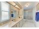 Bathroom with marble countertops, white tile flooring, and shower-tub combo at 5619 Bayshore Rd # 164, Palmetto, FL 34221