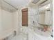 Bathroom featuring wallpaper, bath tub and shower, and a vanity mirror at 5619 Bayshore Rd # 164, Palmetto, FL 34221