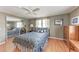 Bedroom with paneled walls, wood-look floors, dresser, and mirrored closet at 5619 Bayshore Rd # 164, Palmetto, FL 34221