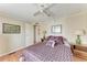 Bedroom with wood-look flooring, ceiling fan, and sliding glass closet doors at 5619 Bayshore Rd # 164, Palmetto, FL 34221