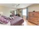 Bedroom with mirrored closet, ceiling fan, wooden floors, and accent furniture at 5619 Bayshore Rd # 164, Palmetto, FL 34221