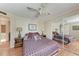 Bright bedroom with ceiling fan, hardwood floors, and mirrored closet doors at 5619 Bayshore Rd # 164, Palmetto, FL 34221