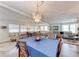 Bright dining room with large chandelier and open layout, seamlessly connecting to the living area at 5619 Bayshore Rd # 164, Palmetto, FL 34221