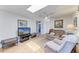 Cozy living room with comfortable seating, natural light, and neutral decor with a large flatscreen TV at 5619 Bayshore Rd # 164, Palmetto, FL 34221