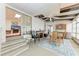 Enclosed patio with dining area, brick fireplace, and sliding glass door to living room at 5619 Bayshore Rd # 164, Palmetto, FL 34221