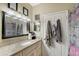 Cozy bathroom featuring a marble countertop and well-lit mirror at 5681 Bidwell Pkwy # 102, Sarasota, FL 34233