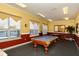 Community billiard room with pool table, comfortable seating, and natural light at 5681 Bidwell Pkwy # 102, Sarasota, FL 34233