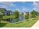 Scenic community view featuring a tranquil pond and manicured green spaces at 5681 Bidwell Pkwy # 102, Sarasota, FL 34233
