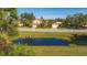 Beautiful homes with well-manicured lawns and lush landscaping, overlooking a serene pond at 5681 Bidwell Pkwy # 102, Sarasota, FL 34233