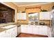 Bright kitchen features granite counters, stainless steel appliances, and white cabinets at 5681 Bidwell Pkwy # 102, Sarasota, FL 34233