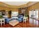 Spacious lounge with high ceilings, stone fireplace, and hardwood floors at 5681 Bidwell Pkwy # 102, Sarasota, FL 34233