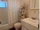 Bathroom with vintage-style vanity and white tile shower and walls at 5895 17Th W St # B-26, Bradenton, FL 34207