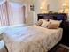 Close-up view of a bedroom with dark furniture and a floral comforter at 5895 17Th W St # B-26, Bradenton, FL 34207