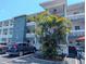 Exterior view of a three-story condominium complex with well-maintained landscaping at 5895 17Th W St # B-26, Bradenton, FL 34207
